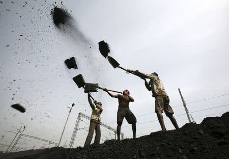 Labourers load coal on trucks at Bari Brahamina on the outskirts of Jammu in this March 16, 2012 file photo. REUTERS/Mukesh Gupta/Files