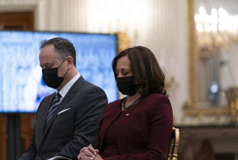 Vice President Kamala Harris, right, and her husband Doug Emhoff, bow their heads in prayer, during a virtual Presidential Inaugural Prayer Service, in the State Dinning Room of the White House, Thursday, Jan. 21, 2021, in Washington. (AP Photo/Alex Brandon)