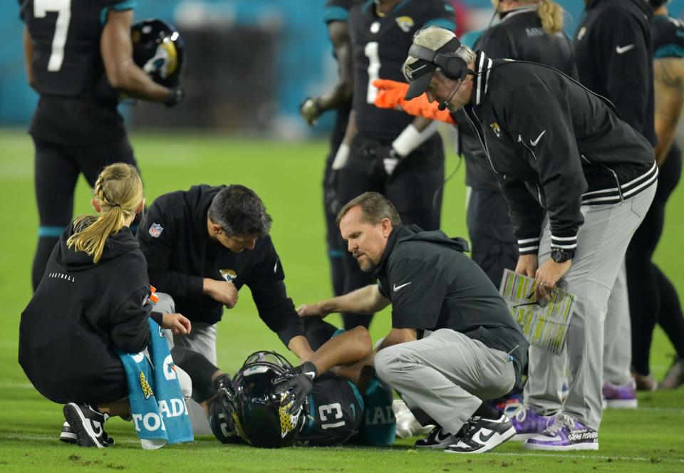 Jacksonville Jaguars wide receiver Christian Kirk (13) is tended to by team personnel as Jacksonville Jaguars head coach Doug Pederson looks on after Kirk was injured early in Monday night's game. The Jacksonville Jaguars hosted the Cincinnati Bengals at EverBank Stadium in Jacksonville, Florida for Monday Night Football, December 4, 2023. The Jaguars were tied 14 to 14 at the end of the first half. [Bob Self/Florida Times-Union]