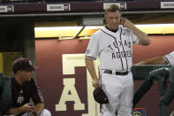 Texas A&M coach Jim Schlossnagle signals to a batter during the team's NCAA college baseball tournament super regional game against Louisville on Friday, June 10, 2022, in College Station, Texas. (AP Photo/Sam Craft)