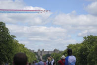 The Red Arrows fly over Windsor Castle, Windsor, England, to mark the official birthday of Queen Elizabeth II, Saturday June 12, 2021. In line with government advice The Queen's Birthday Parade, also known as Trooping the Colour, will not go ahead in its traditional form. (Andrew Matthews/PA via AP)