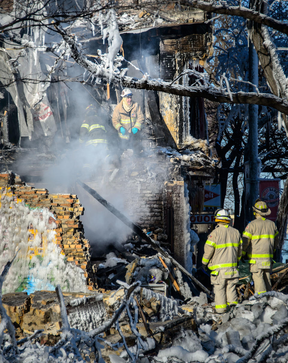 Investigators search for victims, Thursday, Jan. 2, 2014 in Minneapolis. Authorities said Thursday they have discovered a body in the ruins of a Minneapolis apartment fire, as investigators were honing in on natural gas as a potential cause of the explosion and blaze that left 14 other people injured. (AP Photo/The Star Tribune, Glen Stubbe) MANDATORY CREDIT; ST. PAUL PIONEER PRESS OUT; MAGS OUT; TWIN CITIES TV OUT