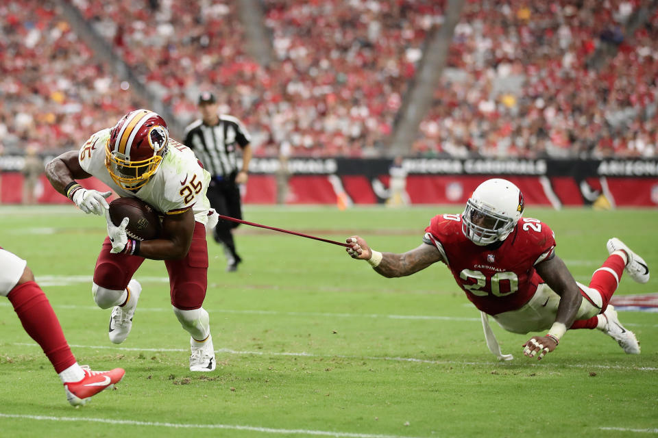 <p>Running back Chris Thompson #25 of the Washington Redskins carries the football as linebacker Deone Bucannon #20 of the Arizona Cardinals attempts a tackle during the first half of the NFL game at State Farm Stadium on September 9, 2018 in Glendale, Arizona. (Photo by Christian Petersen/Getty Images) </p>