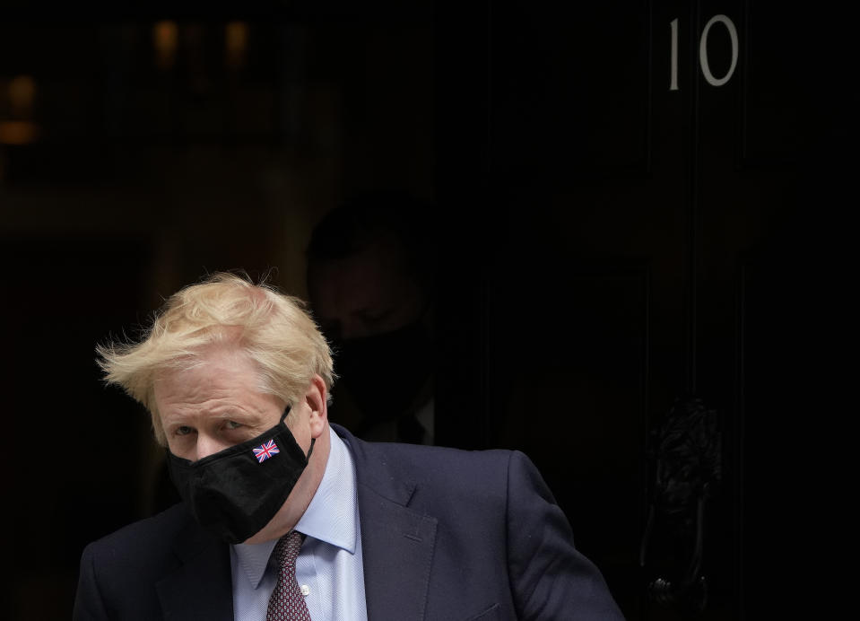Britain's Prime Minister Boris Johnson leaves 10 Downing Street to attend the weekly Prime Ministers' Questions session in parliament in London, Wednesday, May 26, 2021. (AP Photo/Frank Augstein)