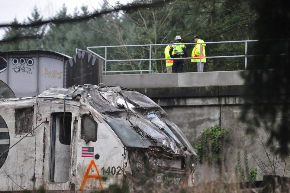 First responders are seen at the scene of an Amtrak passenger train which derailed and is hanging from a bridge over the interstate highway (I-5) in DuPont, Washington.&nbsp;