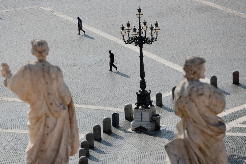 FILE PHOTO: People walk in St. Peter's Square at the Vatican