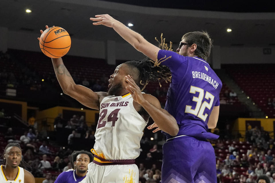 Arizona State forward Bryant Selebangue (24) pulls down a rebound in front of Washington forward Wilhelm Breidenbach (32) during the first half of an NCAA college basketball game Thursday, Feb. 22, 2024, in Tempe, Ariz. (AP Photo/Darryl Webb)