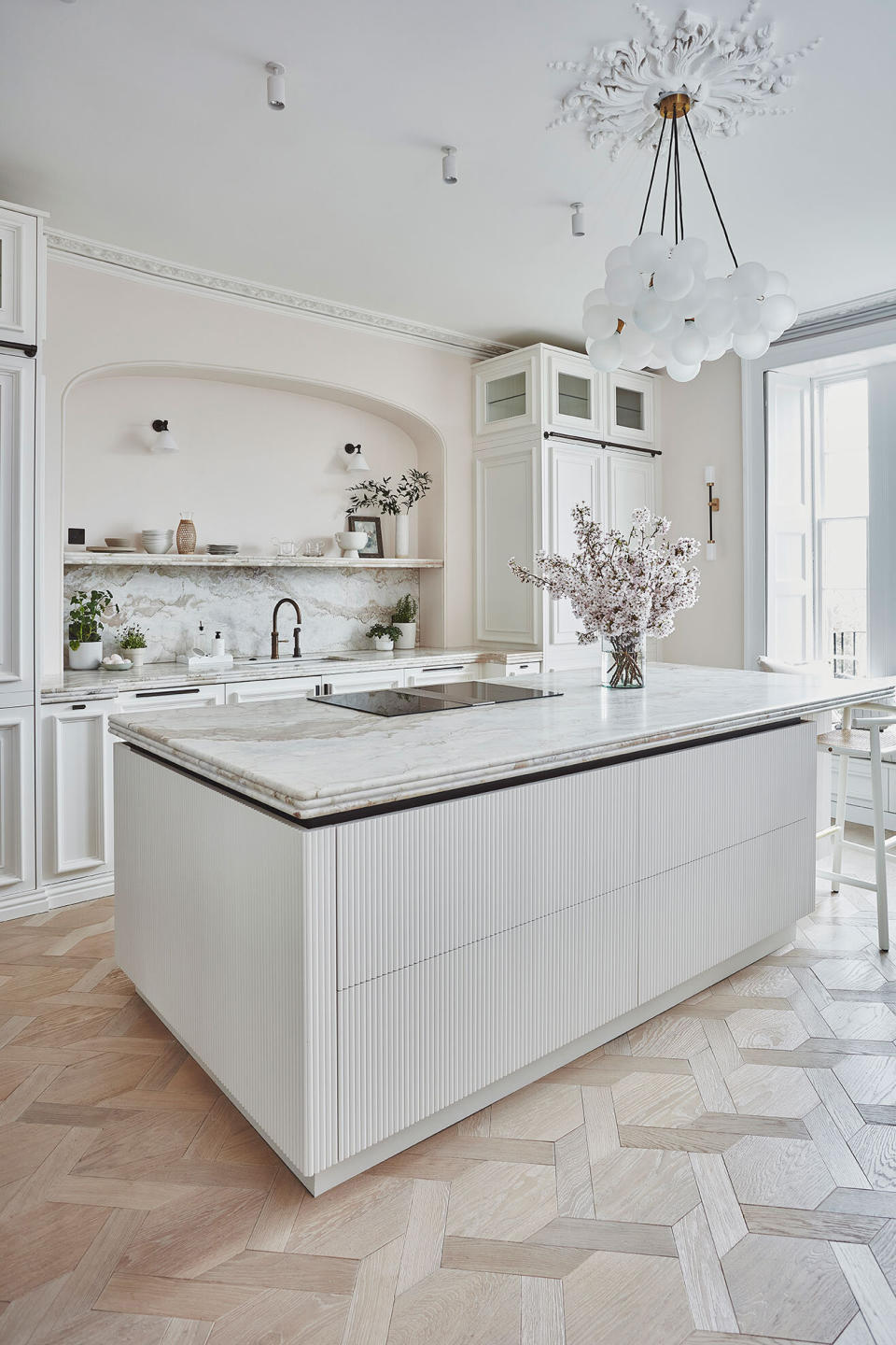 White kitchen with large fluted island