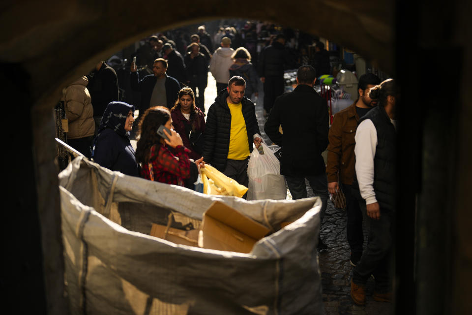 People walk along a street at Eminonu commercial area in Istanbul, Turkey, Wednesday, Feb. 7, 2024. Turkey's new Central Bank chief says tight fiscal policies to tame inflation will continue "with determination" forecasting a 14 per cent inflation rate by the end of 2025. (AP Photo/Francisco Seco)