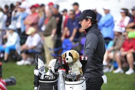 Feb 28, 2014; Palm Beach Gardens, FL, USA; Rory McIlroy rests on his bag on the 18th hole during the second round of the Honda Classic at PGA National GC Champion Course. Mandatory Credit: Bob Donnan-USA TODAY Sports