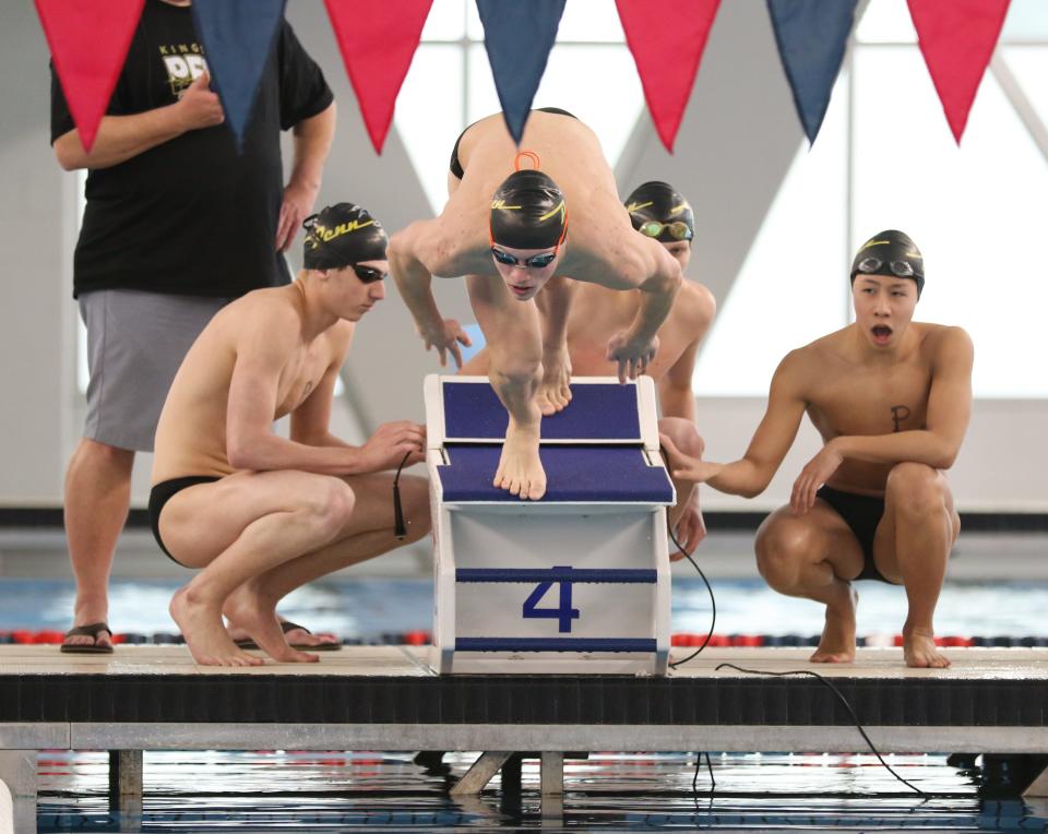 Reid Ohlson of Penn takes off at the start of the 400 Yard Freestyle Relay as his teammates look on during the NIC Boys Swimming Finals Saturday, Jan. 28, 2023 at the Elkhart Aquatics Center.