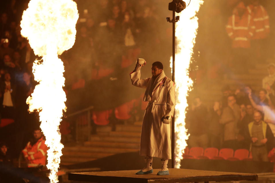 British boxer Anthony Joshua enters the arena for his fight against Russian boxer Alexander Povetkin in their WBA, IBF, WBO and IBO heavyweight titles fight at Wembley Stadium in London, Saturday, Sept. 22, 2018. (AP Photo/Matt Dunham)