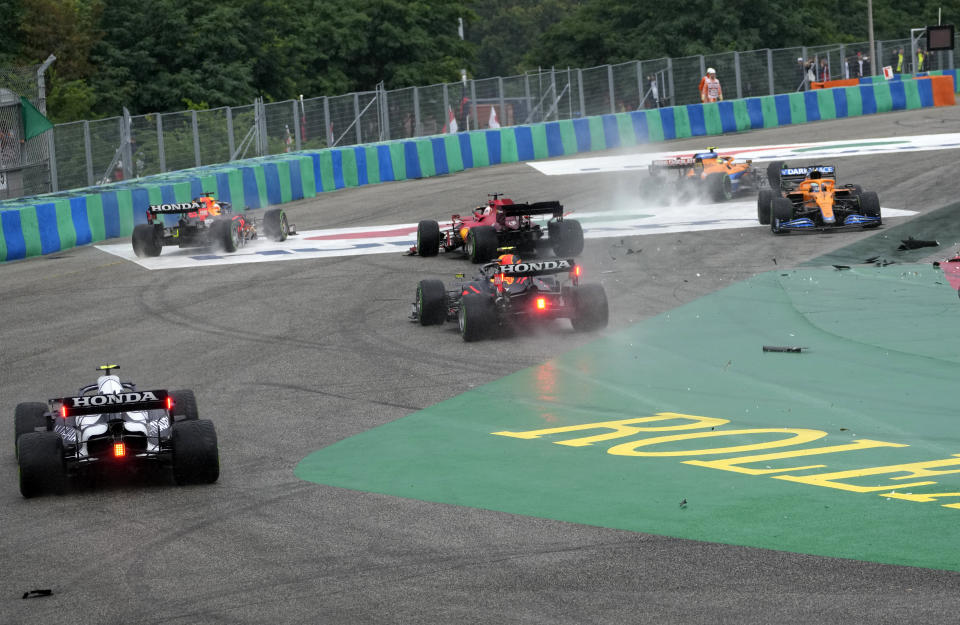 Cars drive out of the track after colliding during the Hungarian Formula One Grand Prix at the Hungaroring racetrack in Mogyorod, Hungary, Sunday, Aug. 1, 2021. (AP Photo/Darko Bandic)