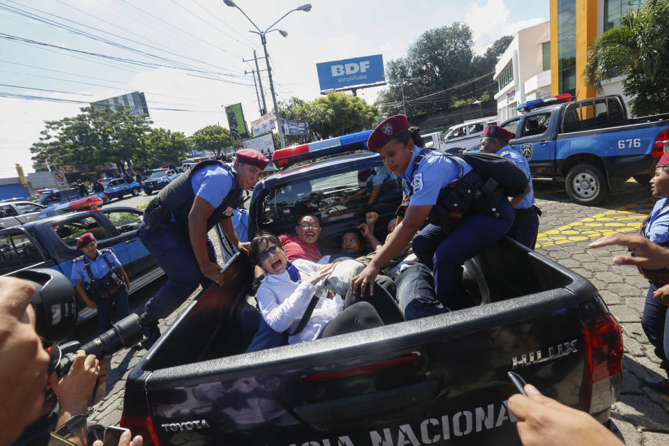 FILE - In this Sunday, Oct. 14, 2018 file photo, anti-government protesters are arrested and taken away by police as the security forces disrupt their "United for Freedom" march in Managua, Nicaragua. Anti-government protests calling for President Daniel Ortega's resignation started in April, triggered by a since-rescinded government plan to cut social security pensions. Ortega said opponents will have to wait until his term ends in 2021. (AP Photo/Alfredo Zuniga, File)