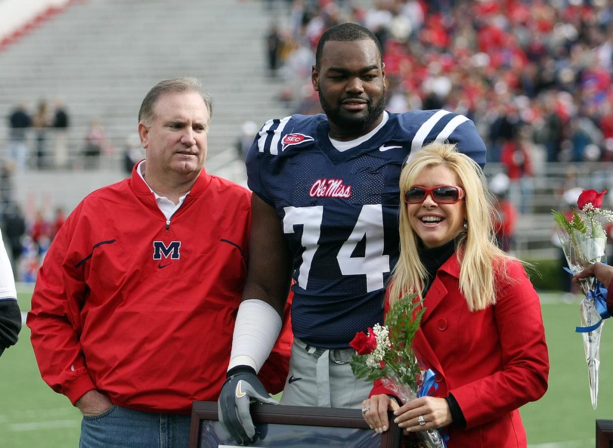 Michael Oher poses with Michael and Anne Leigh Tuohy before an Ole Miss Rebels football game in 2008. <a href="https://www.gettyimages.com/detail/news-photo/michael-oher-of-the-ole-miss-rebels-stands-with-his-family-news-photo/83870434?adppopup=true" rel="nofollow noopener" target="_blank" data-ylk="slk:Matthew Sharpe/Getty Images;elm:context_link;itc:0;sec:content-canvas" class="link ">Matthew Sharpe/Getty Images</a>