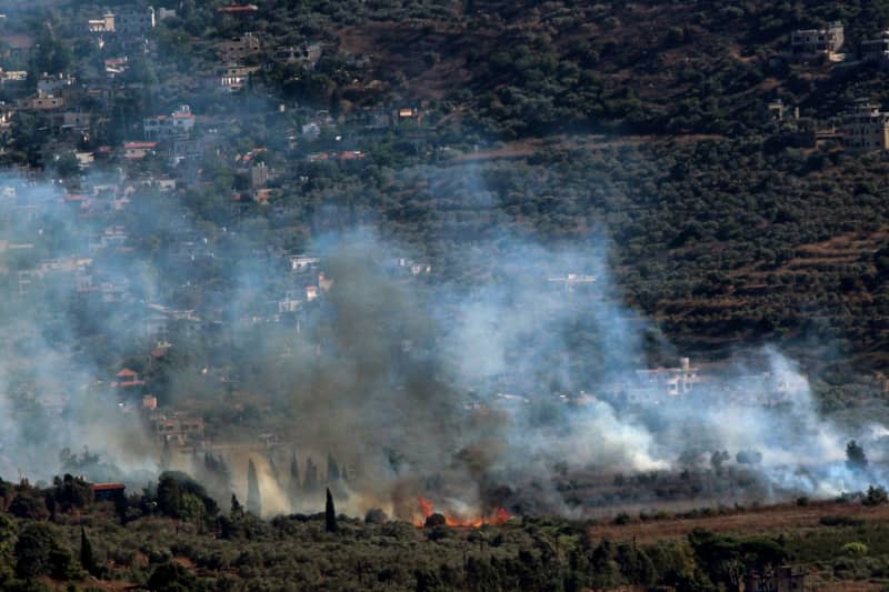 Heavy smoke billow from the Lebanese southern border village of Kfarkela after it was targeted by Israeli shelling. Israel threatened a swift retaliation for an attack from Lebanon that killed 12 children and teenagers in the Druze town of Majdal Shams, in the Israeli-annexed Golan Heights. STR/dpa