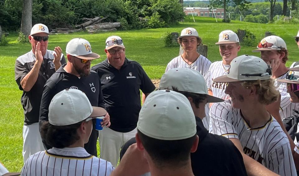 Roger Bacon coach Tim McCoy addresses his team after the win over Reading June 2 in the Division III regional semifinals.