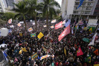 People gather the reading of one of two manifestos defending the nation's democratic institutions and electronic voting system outside the Faculty of Law at Sao Paulo University in Sao Paulo, Brazil, Thursday, Aug. 11, 2022. The two documents are inspired by the original “Letter to the Brazilians” from 1977 denouncing the brutal military dictatorship and calling for a prompt return of the rule of law. (AP Photo/Andre Penner)