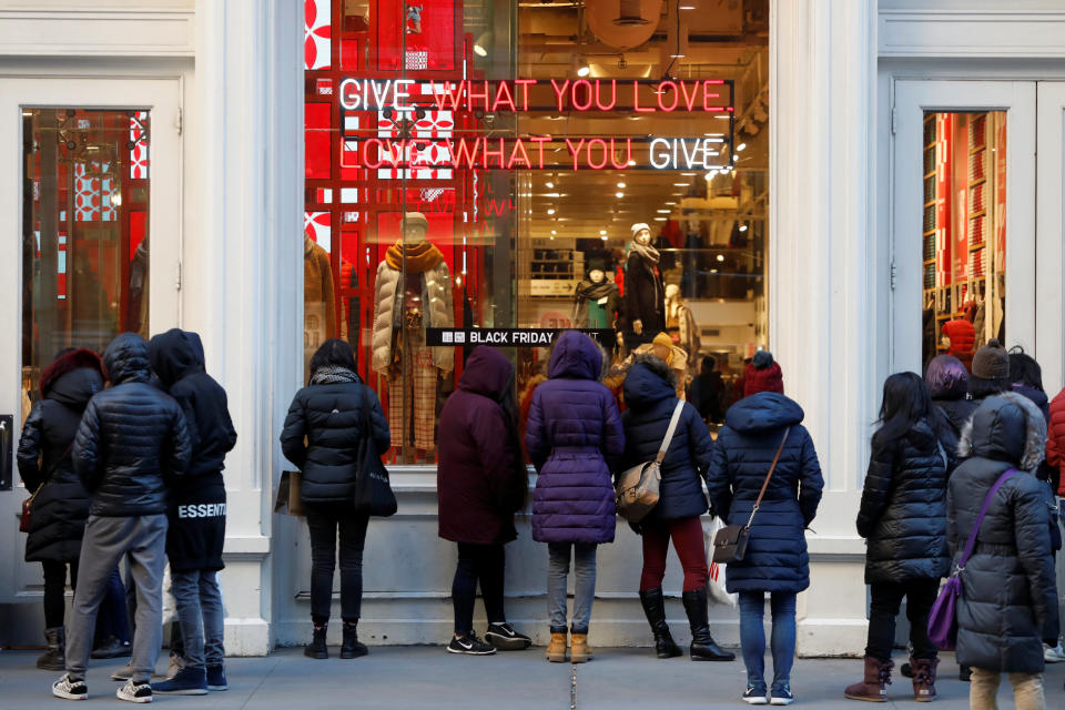 People wait for the Uniqlo store on Broadway to open for a Black Friday sales event in Manhattan, New York City, U.S., November 23, 2018. REUTERS/Andrew Kelly