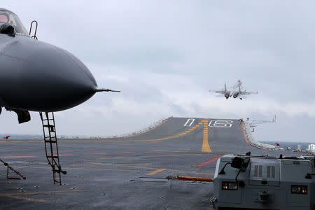 FILE PHOTO: J-15 fighters from China's Liaoning aircraft carrier conduct a drill in an area of South China Sea, January 2, 2017. Picture taken January 2, 2017. REUTERS/Mo Xiaoliang/File Photo