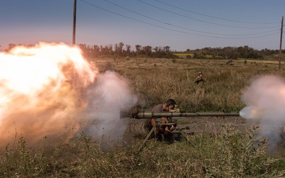 Ukrainian soldiers fire a SPG recoilless gun during a military training
