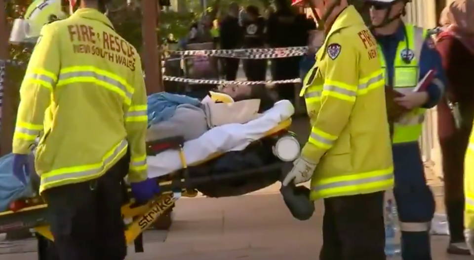 Paramedics shown tending to a victim in a stretcher. Source: Nine News