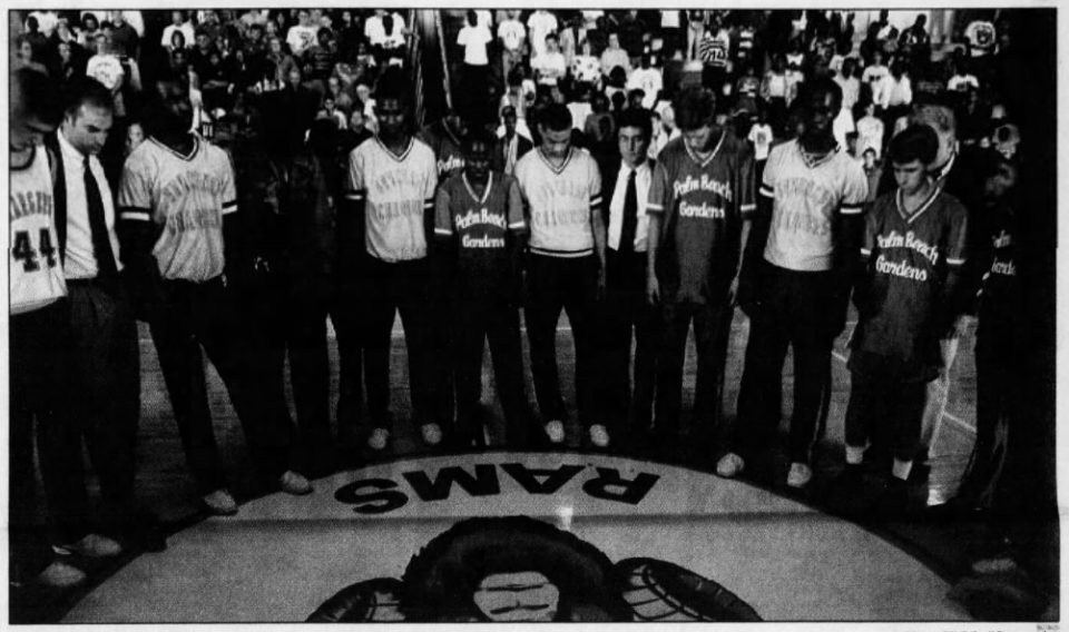 Players and coaches from Suncoast and Palm Beach Gardens hold a moment of silence prior to a game in the Derek Harper Holiday Classic at Palm Beach Lakes High School on Saturday, Dec. 19, 1992. Wilson collapsed and died during Thursday's opening-round game.