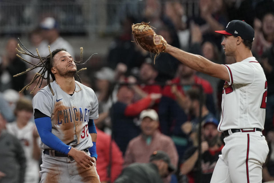 Chicago Cubs' Michael Hermosillo (32) reacts after being tagged out by Atlanta Braves first baseman Matt Olson (28) on a double play in the eighth inning of a baseball gameTuesday, April 26, 2022, in Atlanta. (AP Photo/Brynn Anderson)