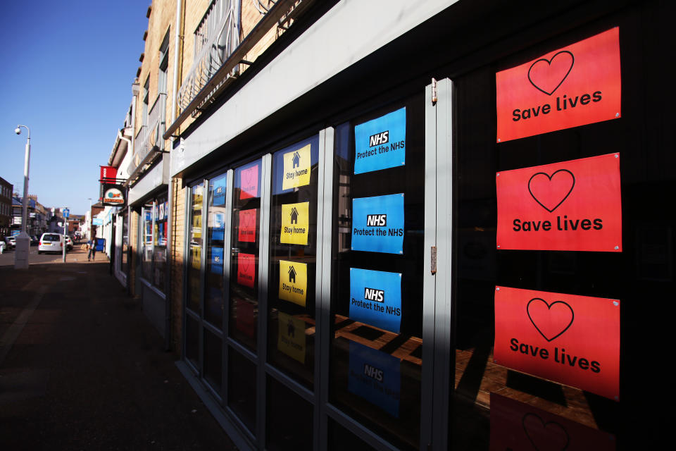Colourful signs in a shop window say 'stay home', 'protect the NHS' and 'save lives' as the UK continues in lockdown to help curb the spread of the coronavirus.