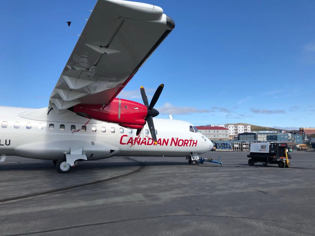 A Canadian North plane at the Iqaluit airport July 2019. (Jordan Konek/CBC - image credit)