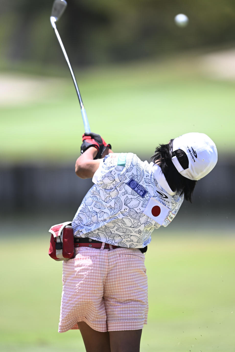 Miroku Suto follows through on her tee shot on the sixth hole during the final round of the Junior World Championships golf tournament held at Singing Hills Golf Resort on Thursday, July 14, 2022, in El Cajon, Calif. (AP Photo/Denis Poroy)