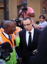 Oscar Pistorius leaves the high court in Pretoria, South Africa, Tuesday, May 13, 2014. Pistorius is charged with murder for the shooting death of his girlfriend, Reeva Steenkamp, on Valentines Day in 2013. (AP Photo/Themba Hadebe)