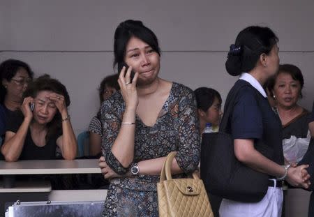 Family members of passengers on board AirAsia flight QZ8501 wait for information inside the AirAsia crisis centre at Juanda Airport in Surabaya, East Java December 28, 2014 in this photo taken by Antara Foto. REUTERS/Antara Foto/Suryanto