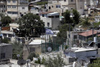 An Israeli flag flies over a Jewish owned house in a Palestinian neighborhood of Silwan in east Jerusalem, Wednesday, July 1, 2020. Israeli leaders paint Jerusalem as a model of coexistence, the "unified, eternal" capital of the Jewish people, where minorities have equal rights. But Palestinian residents face widespread discrimination, most lack citizenship and many live in fear of being forced out. (AP Photo/Mahmoud Illean)