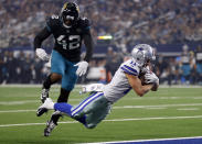 Dallas Cowboys wide receiver Cole Beasley (11) dives into the end zone in front of Jacksonville Jaguars strong safety Barry Church (42) for a touchdown in the first half of an NFL football game in Arlington, Texas, Sunday, Oct. 14, 2018. (AP Photo/Ron Jenkins)