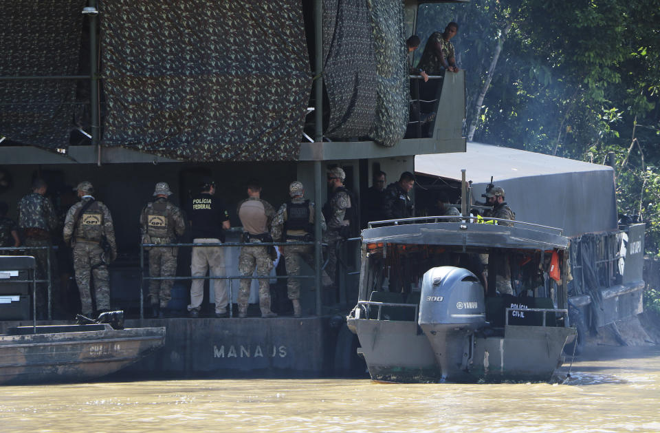 Federal police officers gather on an Army floating base during the search for Indigenous expert Bruno Pereira and freelance British journalist Dom Phillips in Atalaia do Norte, Amazonas state, Brazil, Tuesday, June 14, 2022. The search for Pereira and Phillips, who disappeared in a remote area of Brazil's Amazon continues following the discovery of a backpack, laptop and other personal belongings submerged in a river. (AP Photo/Edmar Barros)