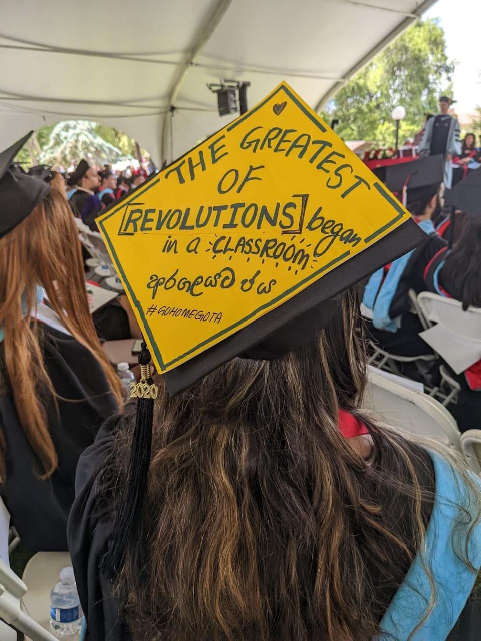 Kavindya Thennakoon's graduation cap reads "The greatest of revolutions began in a classroom #GoHomeGota" during her graduation ceremony this summer from Stanford's School of Education.