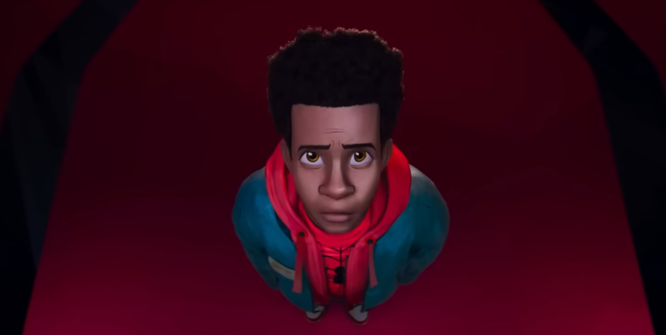 Miles in Spider-Man Across the Spiderverse looking at a costume