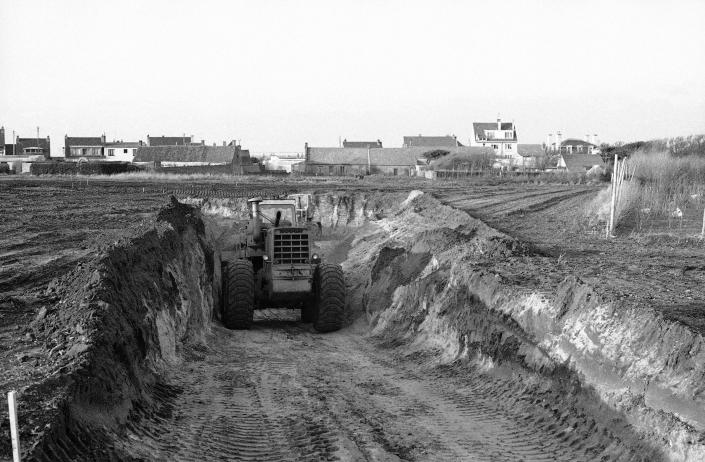 A bulldozer clears a descent path to move equipment down to the level for drilling operations as workmen start excavations for building the Channel Tunnel outside Calais, France, Nov. 17, 1973