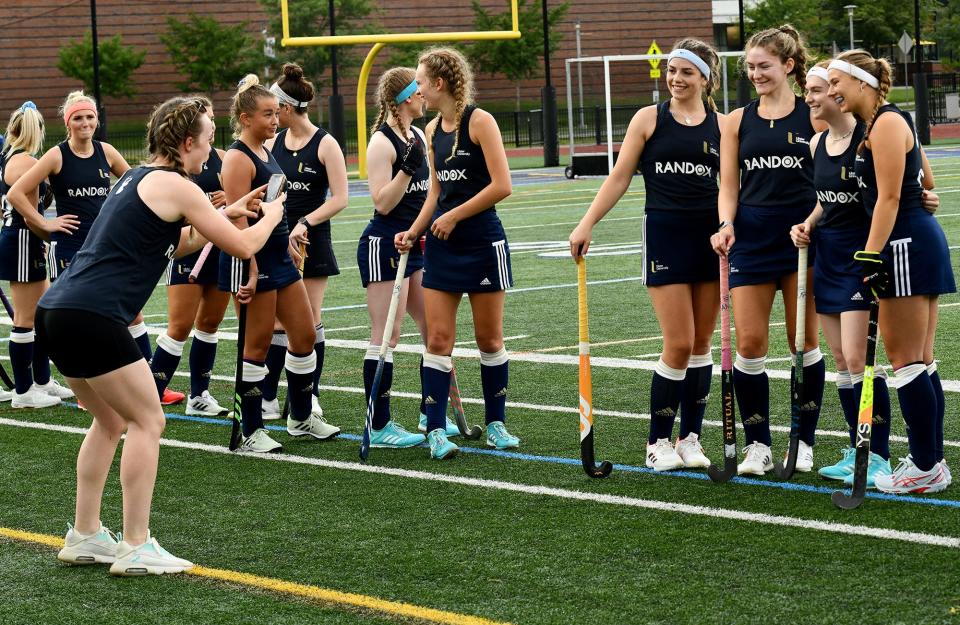 Northern Ireland's Ulster University field hockey club, the Elks, take a photo on the field before playing Worcester State during its tour of New England on Tuesday.