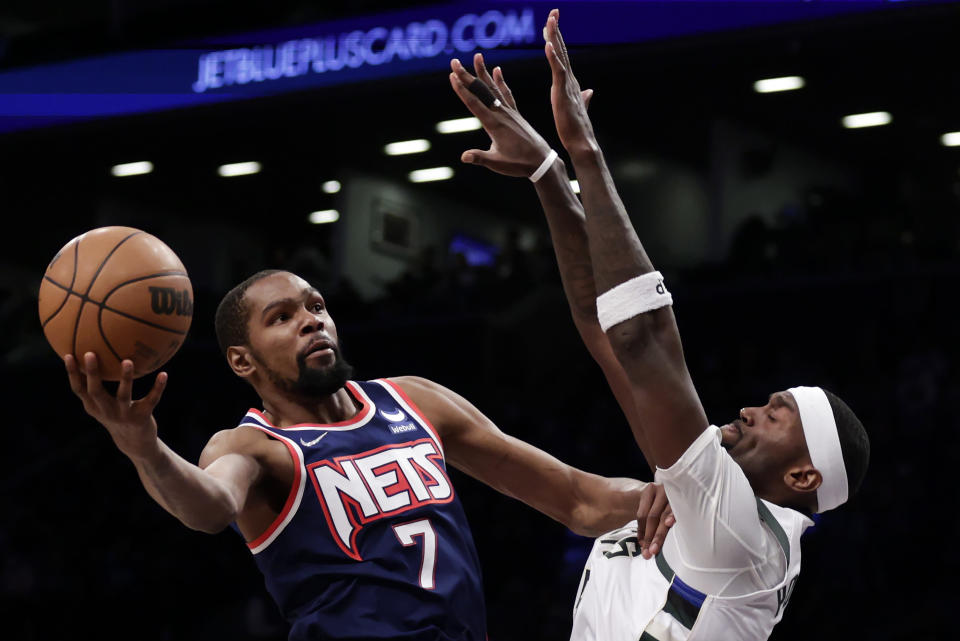 Brooklyn Nets forward Kevin Durant (7) drives to the basket against Milwaukee Bucks center Bobby Portis during the first half of an NBA basketball game Friday, Jan. 7, 2022, in New York. (AP Photo/Adam Hunger)