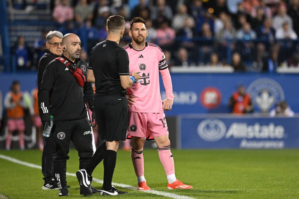 Inter Miami CF forward Lionel Messi (10) talks with trainers during the first half against CF Montreal at Stade Saputo in Montreal on May 11, 2024.