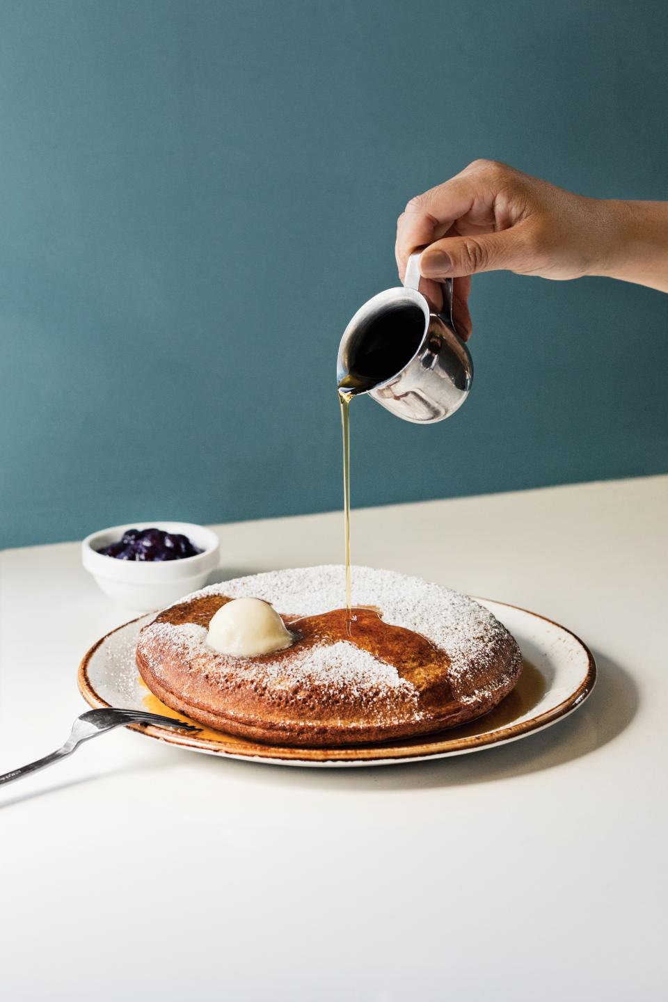 The buckwheat pancake from Friends & Family gets drizzled with maple syrup.