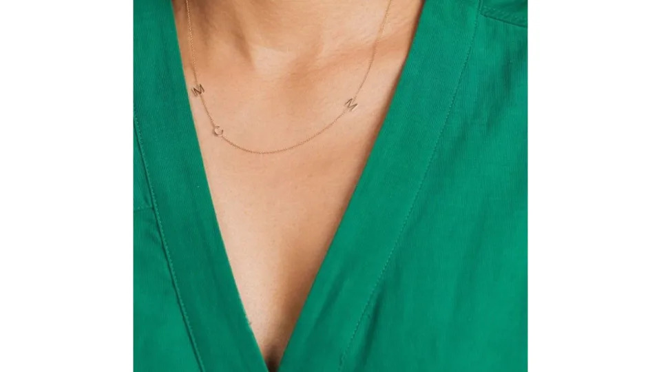 Meghan Markle wore this Maya Brenner charm intial necklace when first dating Prince Harry