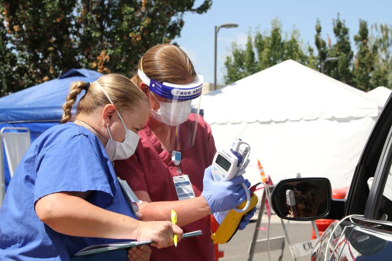 U.S. Air Force Major Alisha Florence works with Tammy Giordano, a nurse at Adventist Health Lodi Memorial in Lodi