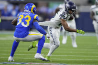 Seattle Seahawks wide receiver Tyler Lockett (16) runs with the ball as Los Angeles Rams safety Nick Scott (33) defends during the second half of an NFL football game Sunday, Dec. 4, 2022, in Inglewood, Calif. (AP Photo/Marcio Jose Sanchez)