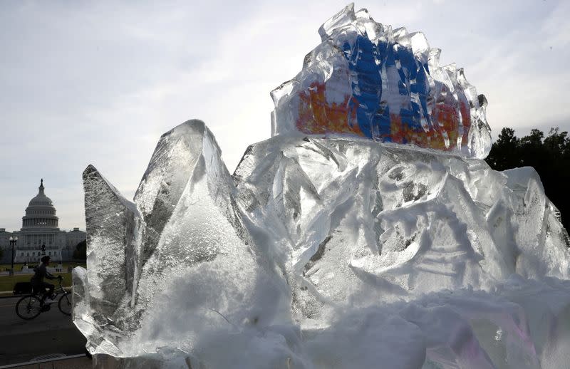 FILE PHOTO: Climate activists melt ice to protest Facebook’s role in allowing climate misinformation to spread