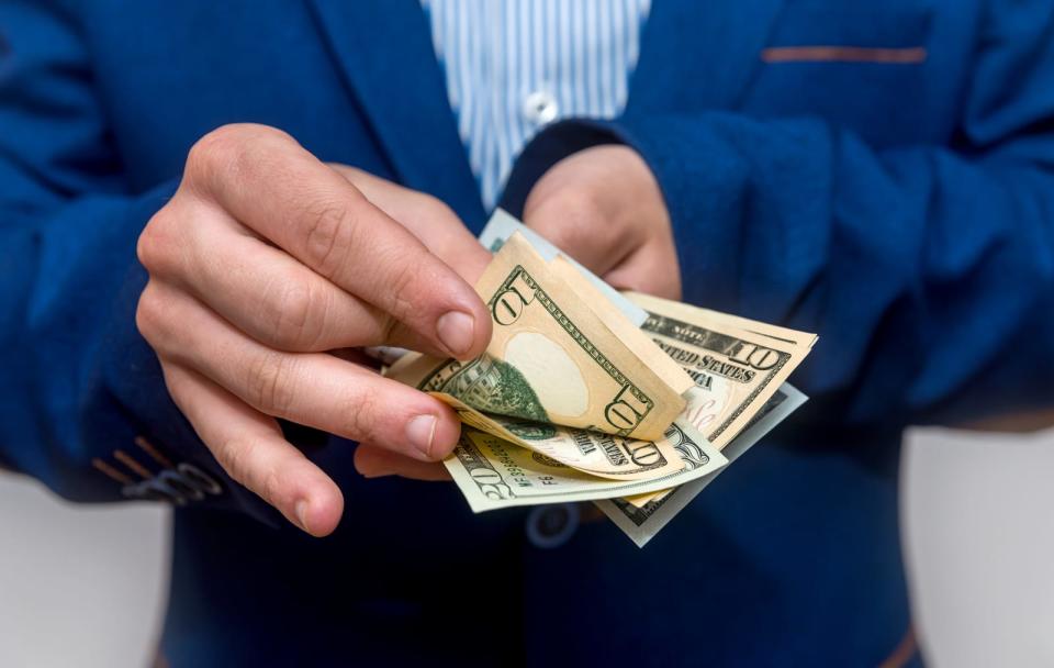 Male hands counting dollar banknotes close up