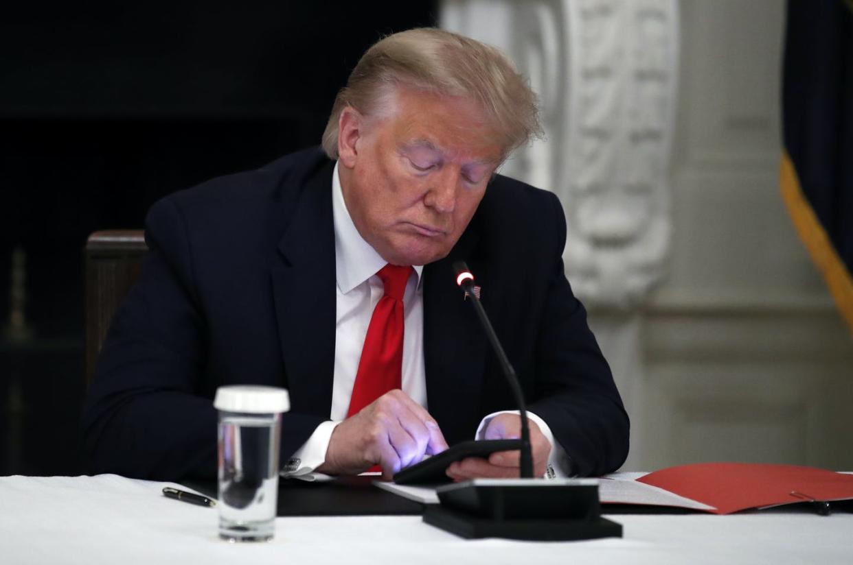 <span class="caption">President <span class="caas-xray-inline-tooltip"><span class="caas-xray-inline caas-xray-entity caas-xray-pill rapid-nonanchor-lt" data-entity-id="Donald_Trump" data-ylk="cid:Donald_Trump;pos:1;elmt:wiki;sec:pill-inline-entity;elm:pill-inline-text;itc:1;cat:Politician;" tabindex="0" aria-haspopup="dialog"><a href="https://search.yahoo.com/search?p=Donald%20Trump" data-i13n="cid:Donald_Trump;pos:1;elmt:wiki;sec:pill-inline-entity;elm:pill-inline-text;itc:1;cat:Politician;" tabindex="-1" data-ylk="slk:Donald Trump;cid:Donald_Trump;pos:1;elmt:wiki;sec:pill-inline-entity;elm:pill-inline-text;itc:1;cat:Politician;" class="link ">Donald Trump</a></span></span> uses his smartphone.</span> <span class="attribution"><a class="link " href="https://newsroom.ap.org/detail/Trump-SocialMediaBans/1deda14e260e40a5b24a2a905e43a5f2/photo" rel="nofollow noopener" target="_blank" data-ylk="slk:AP Photo/Alex Brandon;elm:context_link;itc:0;sec:content-canvas">AP Photo/Alex Brandon</a></span>