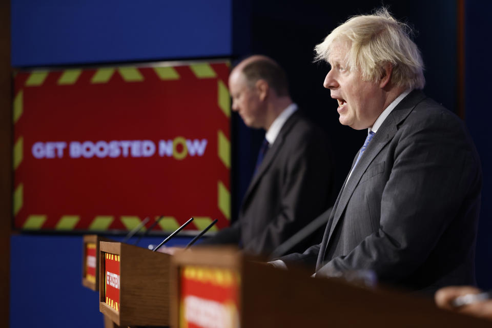 Chief Medical Officer for England Professor Chris Whitty (left) listens to Prime Minister Boris Johnson during a media briefing in Downing Street, London, on coronavirus (Covid-19). Picture date: Wednesday December 15, 2021.